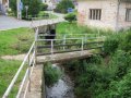 Pohled na Červenovodský potok s četnými mostky v obci Červená Voda_I