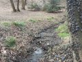 Otevřené koryto Lulečského potoka v intravilánu obce 